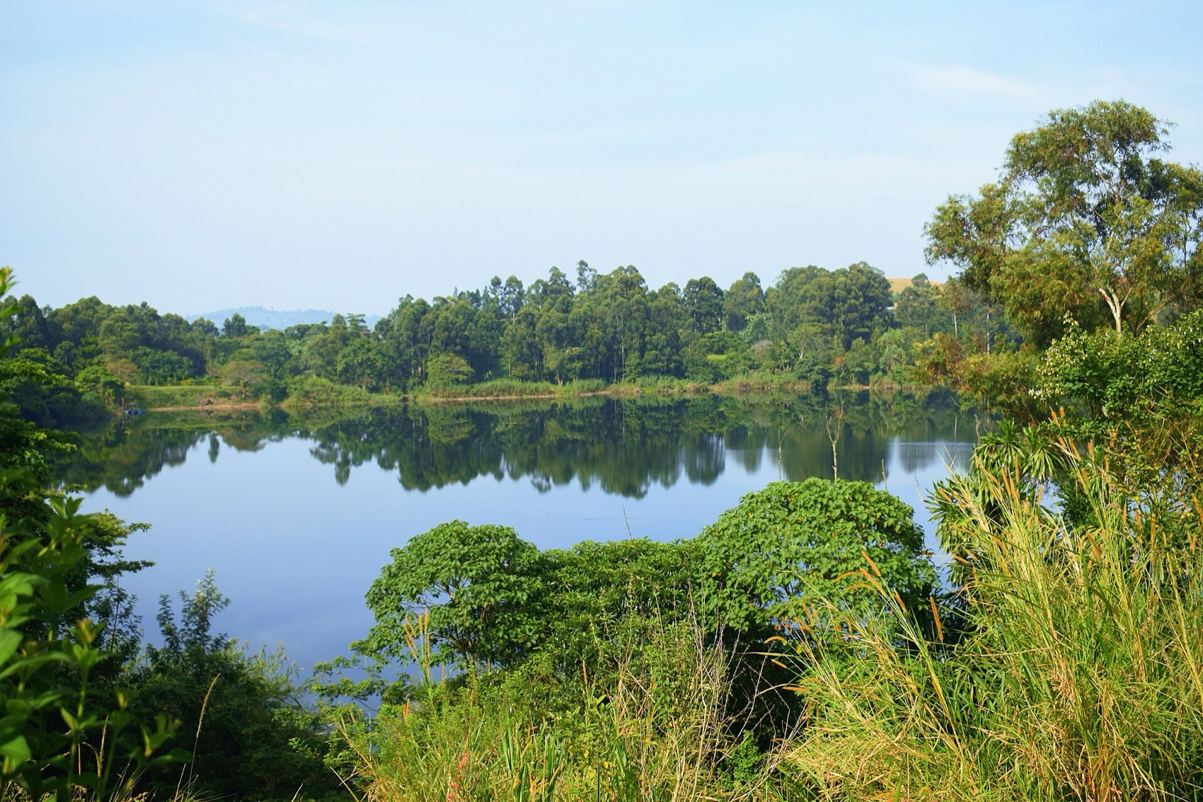 A deep green crater lake ringed by forest near Fort Portal